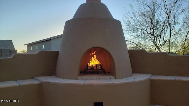 exterior space featuring a lit fireplace