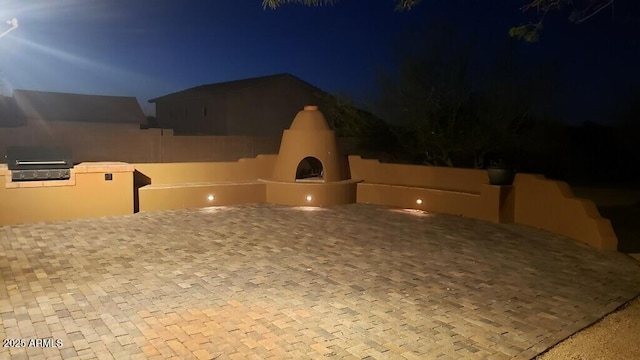 exterior space with an outdoor fireplace
