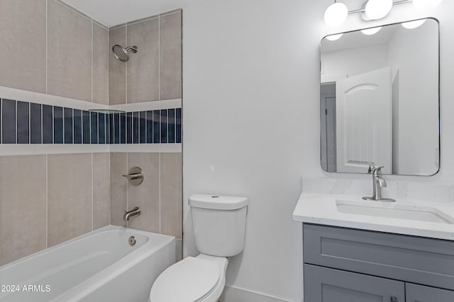 full bathroom featuring vanity, toilet, and tiled shower / bath