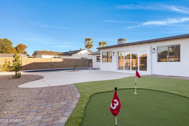 exterior space with a patio area and a pool