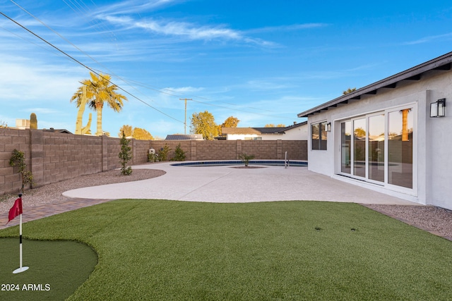 view of yard with a patio and a fenced in pool