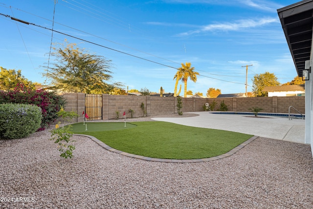 view of yard featuring a fenced in pool and a patio area