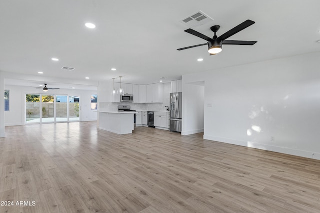 unfurnished living room with ceiling fan and light wood-type flooring