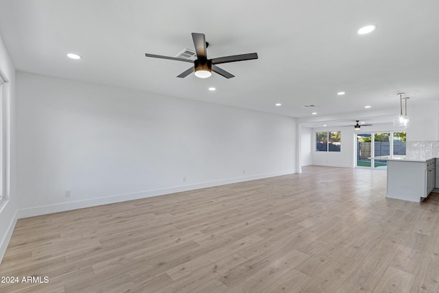 unfurnished living room featuring light hardwood / wood-style floors and ceiling fan