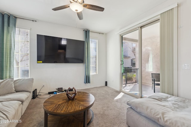 living room featuring ceiling fan, a healthy amount of sunlight, and light carpet