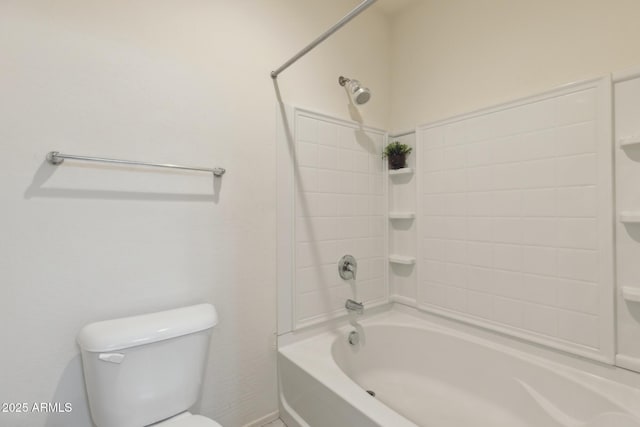 bathroom featuring tiled shower / bath and toilet