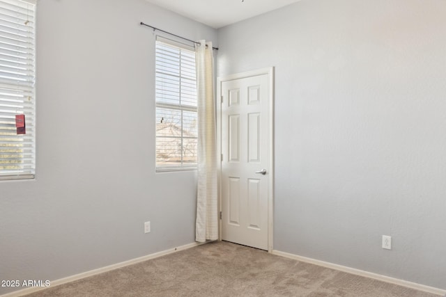 carpeted spare room featuring a healthy amount of sunlight