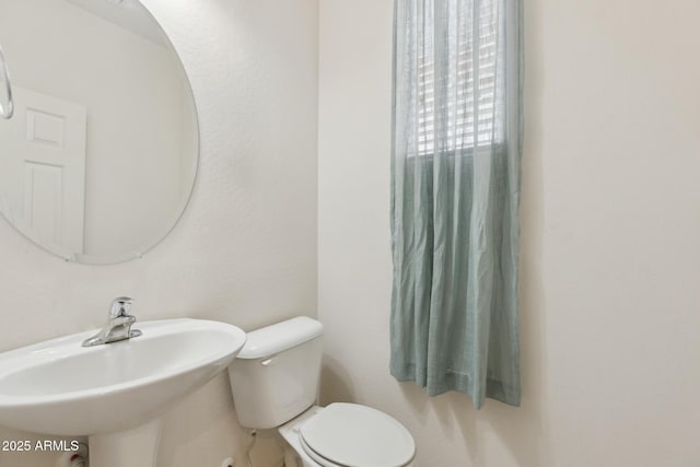 bathroom with toilet and sink