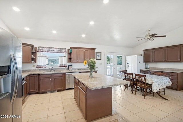 8343 W Calle Lejos, Peoria, AZ 85383 - kitchen with open shelves, stainless steel appliances, a sink, french doors, and a center island