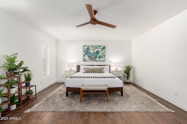 bedroom with ceiling fan and dark hardwood / wood-style floors