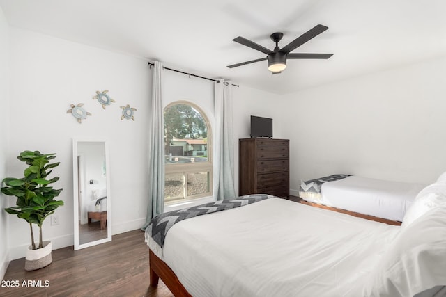 bedroom with ceiling fan and dark hardwood / wood-style flooring