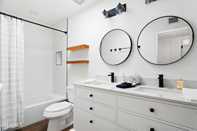 full bathroom featuring vanity, hardwood / wood-style floors, toilet, and shower / bath combo