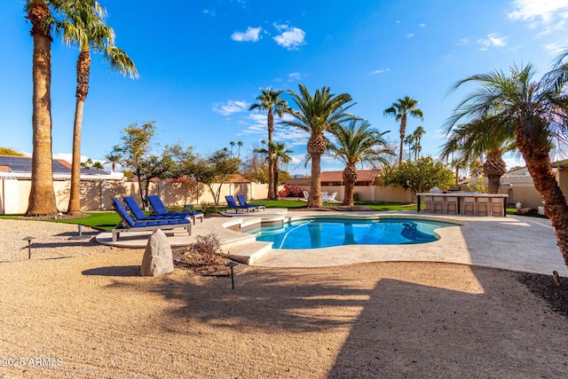 view of swimming pool with a bar and a patio