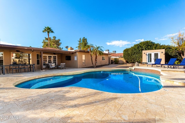 view of swimming pool featuring a patio, french doors, and ceiling fan