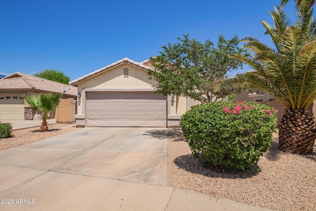 3821 N 125th Dr, Avondale, AZ 85392 - view of front of home with stucco siding, driveway, a garage, and a tiled roof