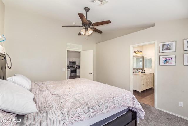 3821 N 125th Dr, Avondale, AZ 85392 - bedroom with dark carpet, vaulted ceiling, ensuite bathroom, and a ceiling fan