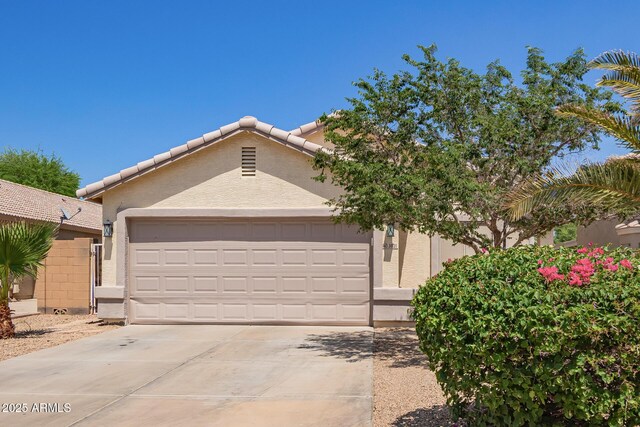 3821 N 125th Dr, Avondale, AZ 85392 - view of front of property featuring driveway, an attached garage, stucco siding, and a tile roof