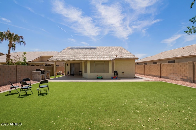 3821 N 125th Dr, Avondale, AZ 85392 - back of house featuring solar panels, a fenced backyard, a patio area, a tiled roof, and stucco siding