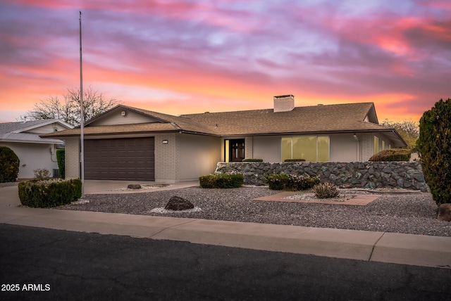 ranch-style house featuring a garage