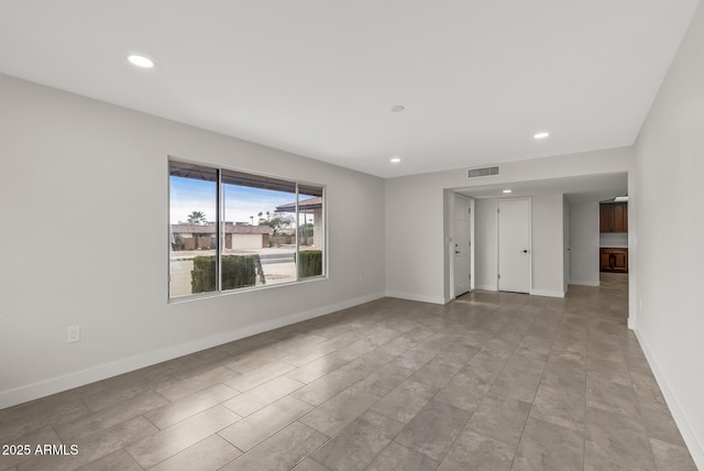empty room with recessed lighting, baseboards, and visible vents