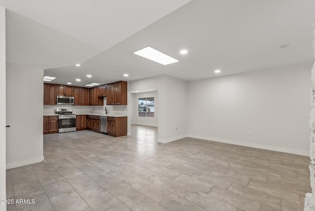 kitchen with recessed lighting, light countertops, baseboards, and appliances with stainless steel finishes