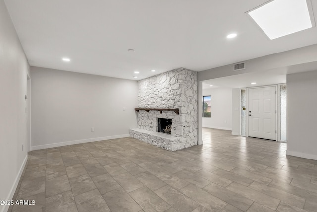 unfurnished living room with baseboards, visible vents, recessed lighting, and a fireplace