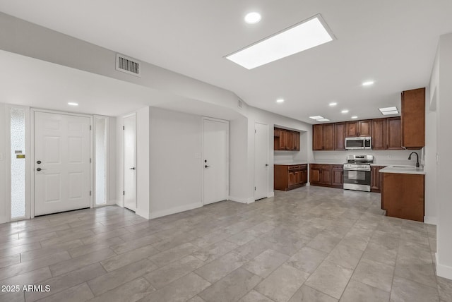 kitchen with light countertops, a sink, appliances with stainless steel finishes, visible vents, and recessed lighting