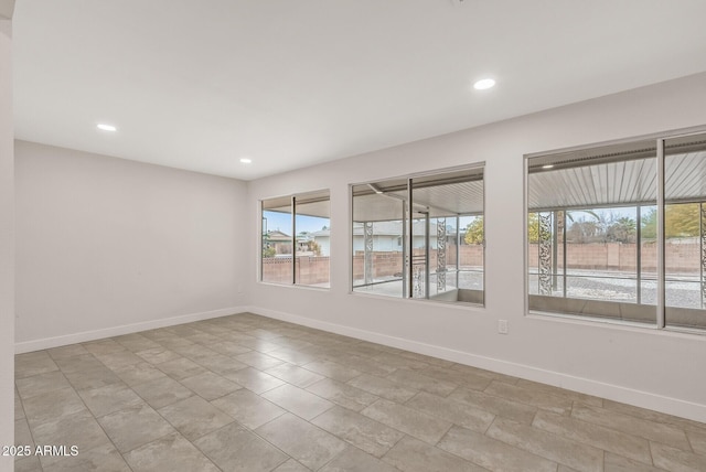 unfurnished room with baseboards and recessed lighting