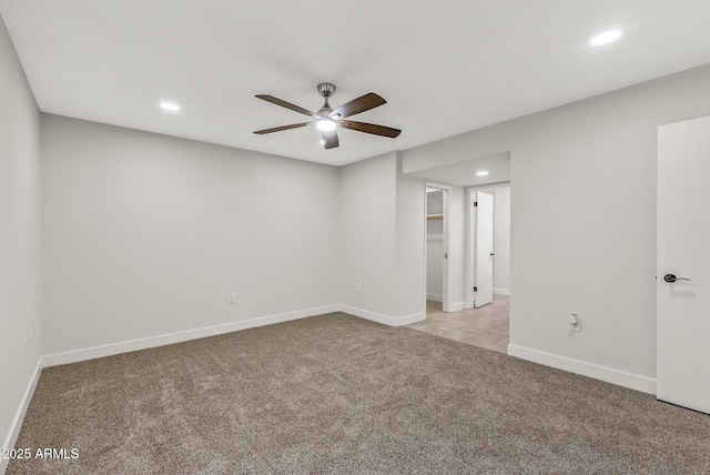 empty room featuring a ceiling fan, baseboards, light colored carpet, and recessed lighting