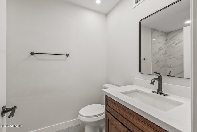 bathroom featuring toilet, vanity, baseboards, and visible vents