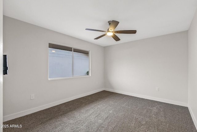 carpeted empty room with baseboards and ceiling fan