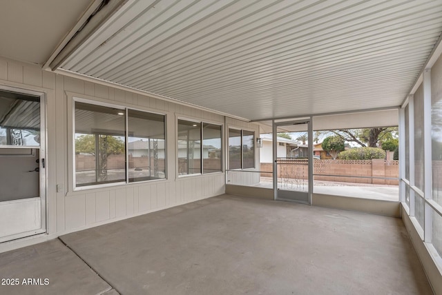 unfurnished sunroom featuring a wealth of natural light