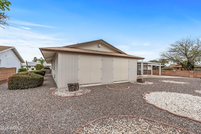 back of property featuring fence and a patio area