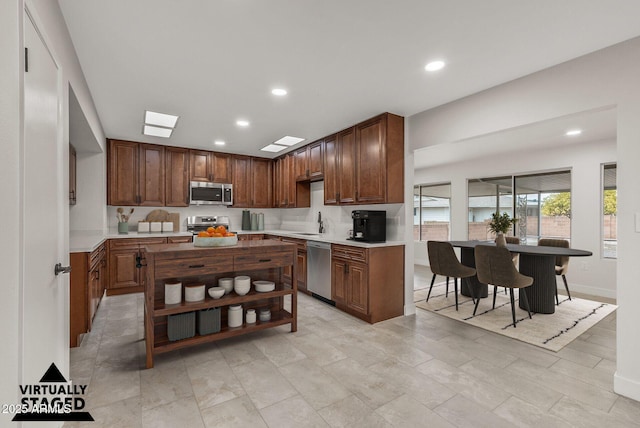 kitchen with a sink, appliances with stainless steel finishes, open shelves, and recessed lighting