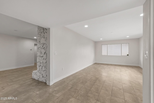 spare room with baseboards and recessed lighting