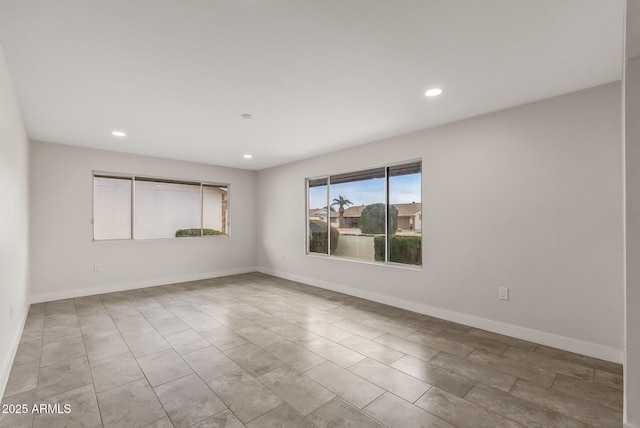 unfurnished room featuring baseboards and recessed lighting