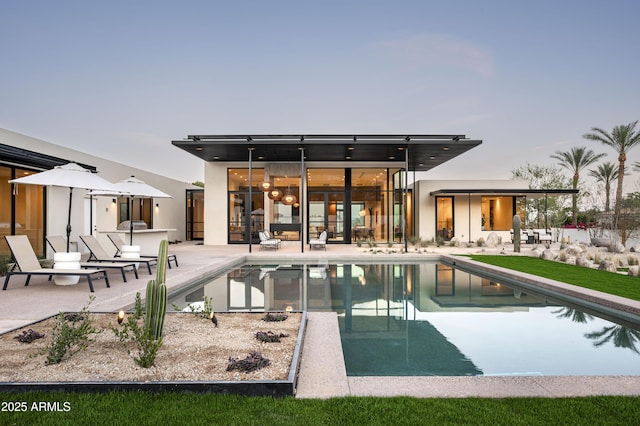 back of house with a patio area and an outdoor pool