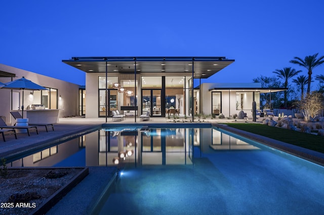 pool with outdoor dry bar and a patio area