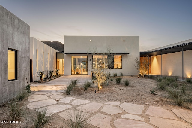 back of house with stucco siding
