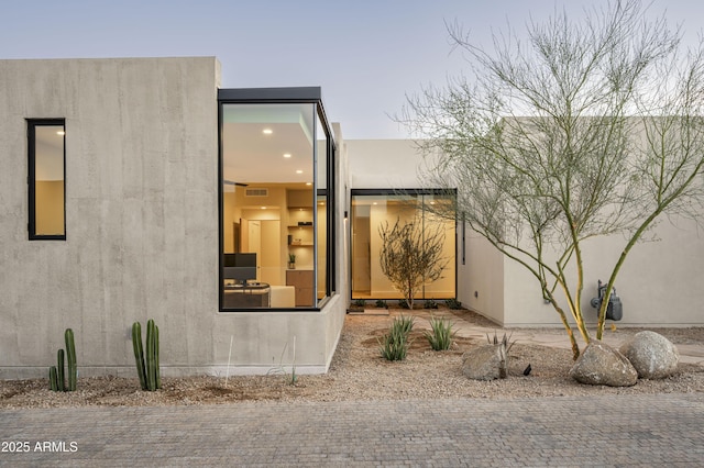 view of side of property featuring stucco siding