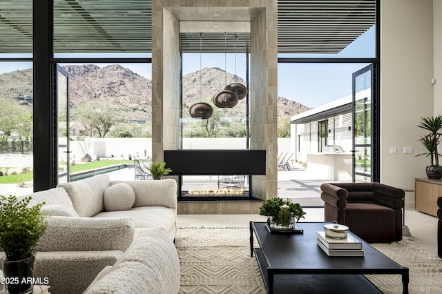 interior space with a mountain view and a multi sided fireplace