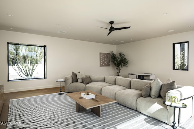living area with ceiling fan, recessed lighting, wood finished floors, visible vents, and baseboards