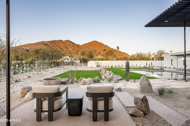 view of patio / terrace featuring a fenced backyard, a mountain view, and a fenced in pool