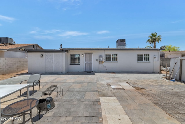 rear view of property with a patio and central AC unit