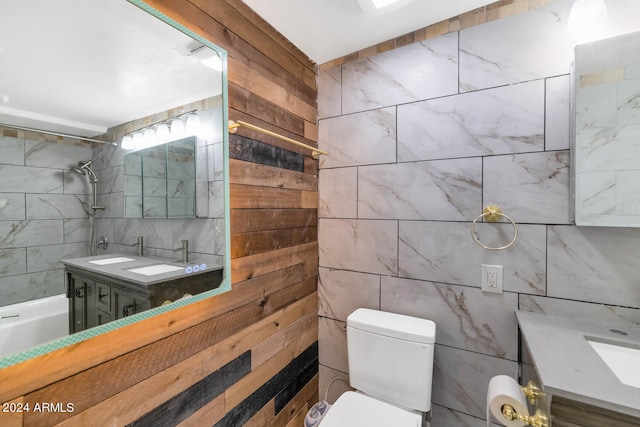 bathroom featuring vanity, toilet, and tile walls