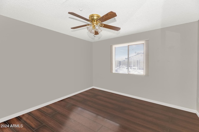 spare room featuring ceiling fan, dark hardwood / wood-style flooring, and a textured ceiling