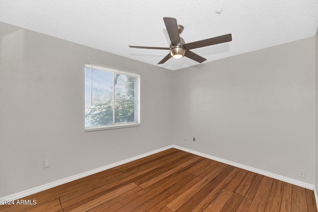 spare room featuring hardwood / wood-style floors, ceiling fan, and a textured ceiling