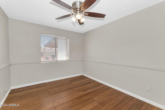 spare room with dark hardwood / wood-style floors, ceiling fan, and a textured ceiling