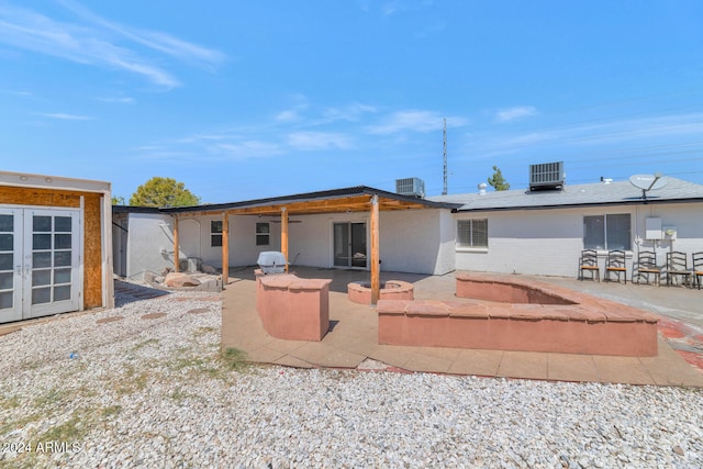 rear view of property featuring a patio and central AC unit