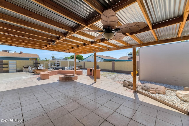 view of patio with ceiling fan and an outdoor fire pit